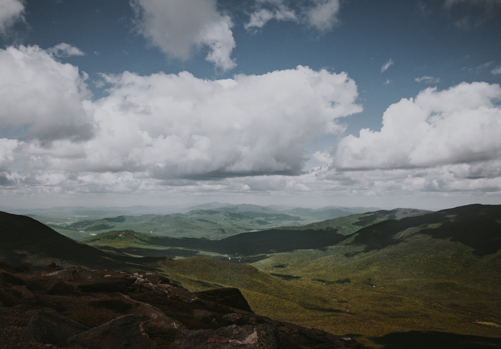 green and black mountains under white sky