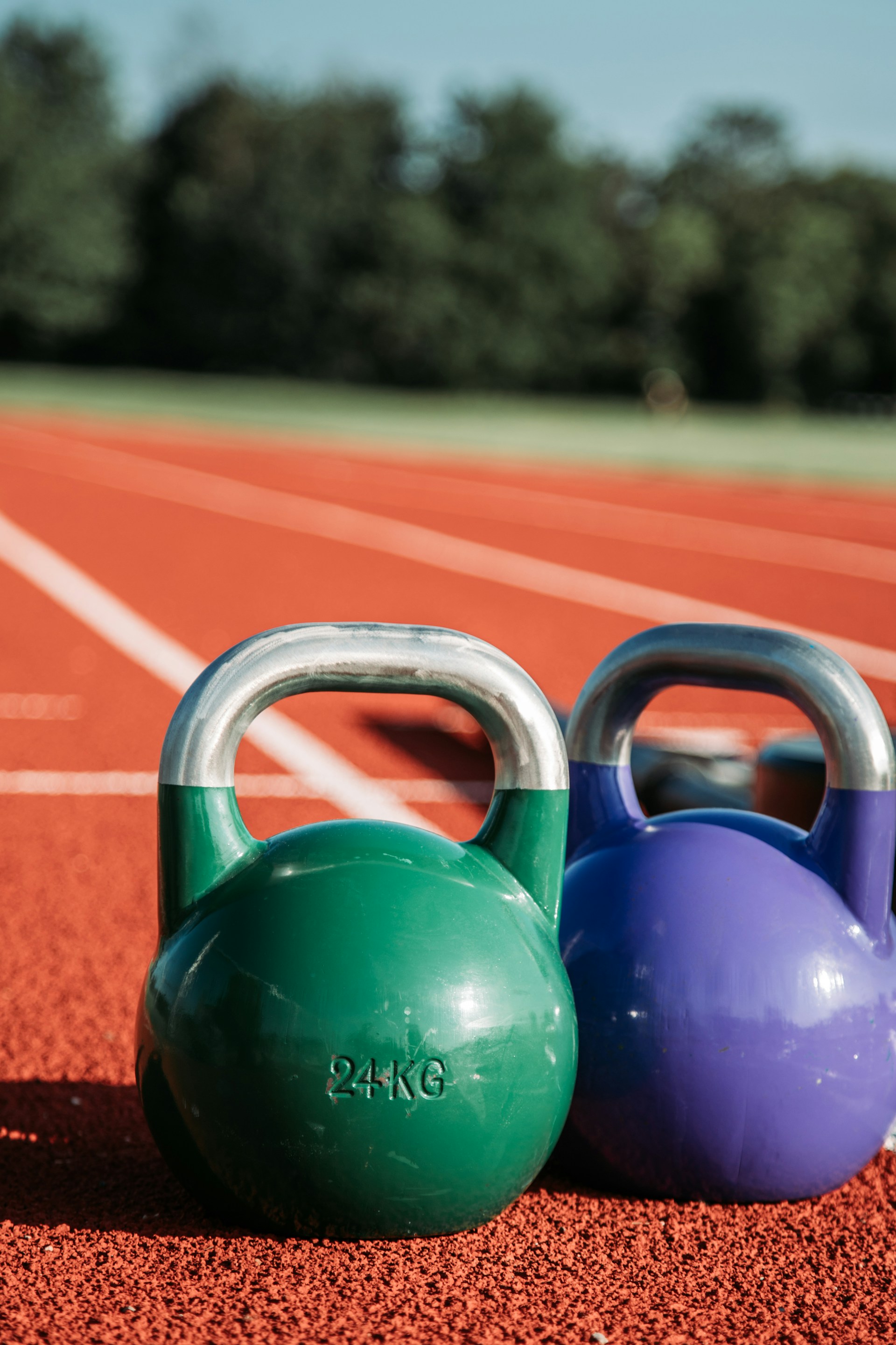 two green and purple kettle bells