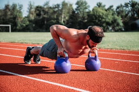man exercising on field during daytime