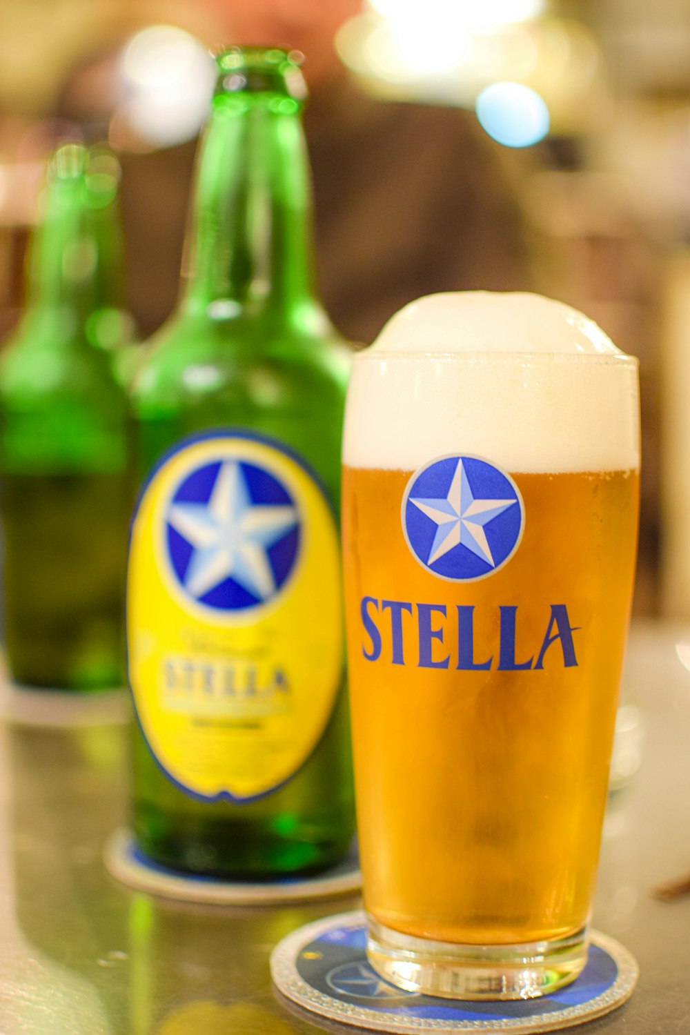 a close up of a glass of beer on a table