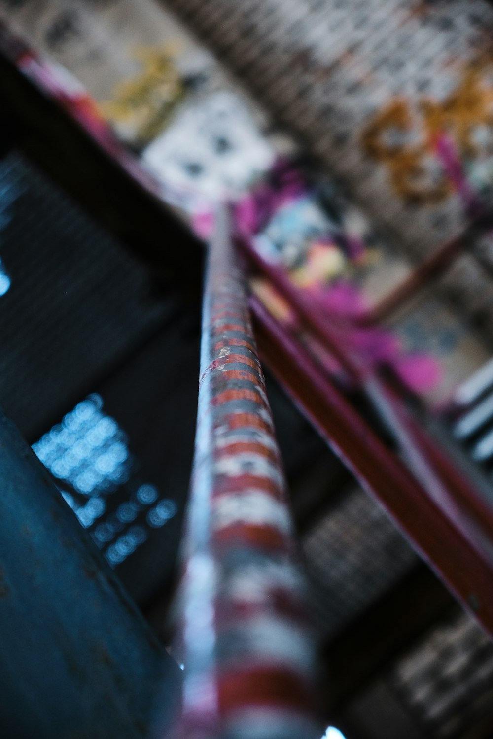 a close up of a metal pole with graffiti on it