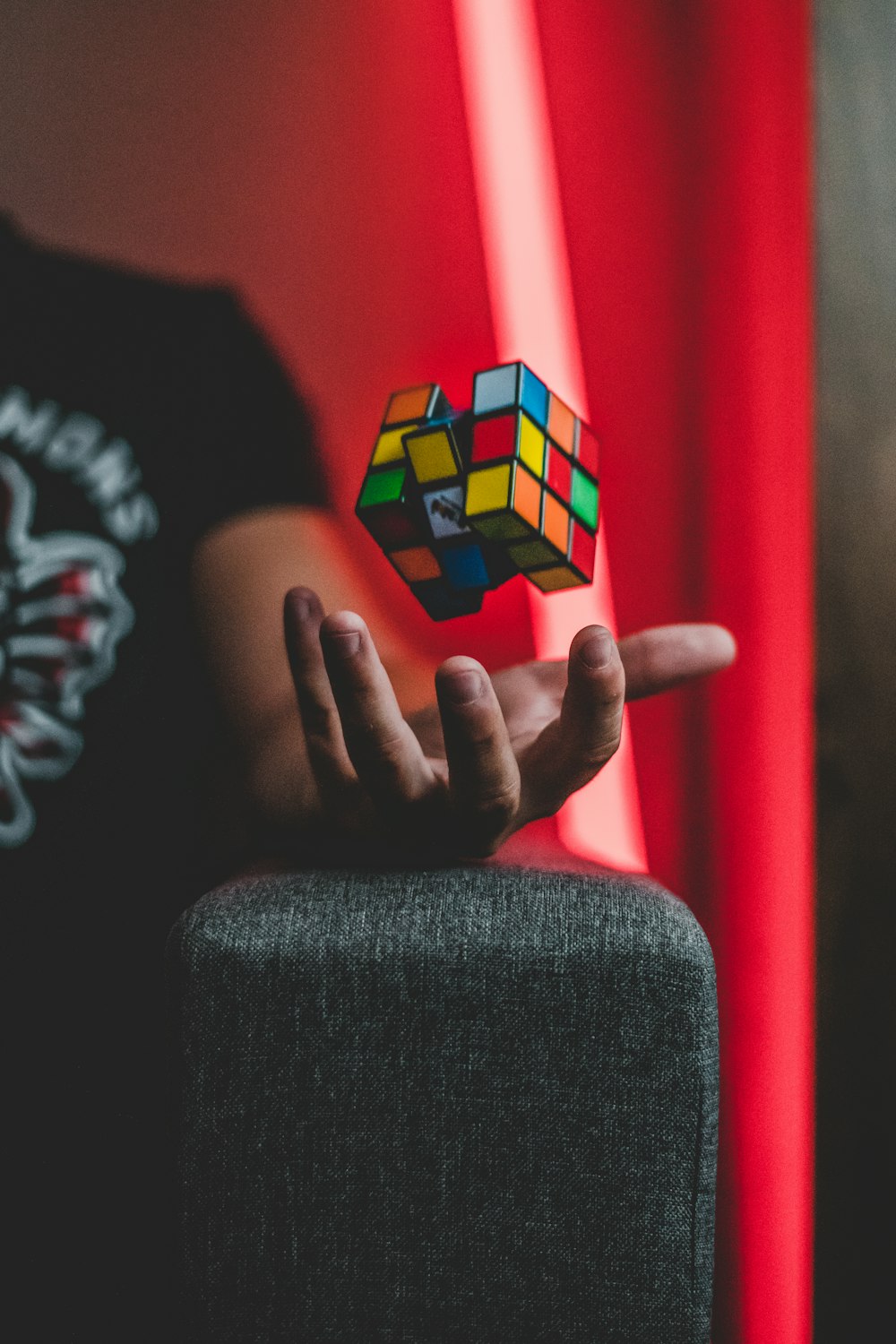 person tossing 3x3 Rubik's cube