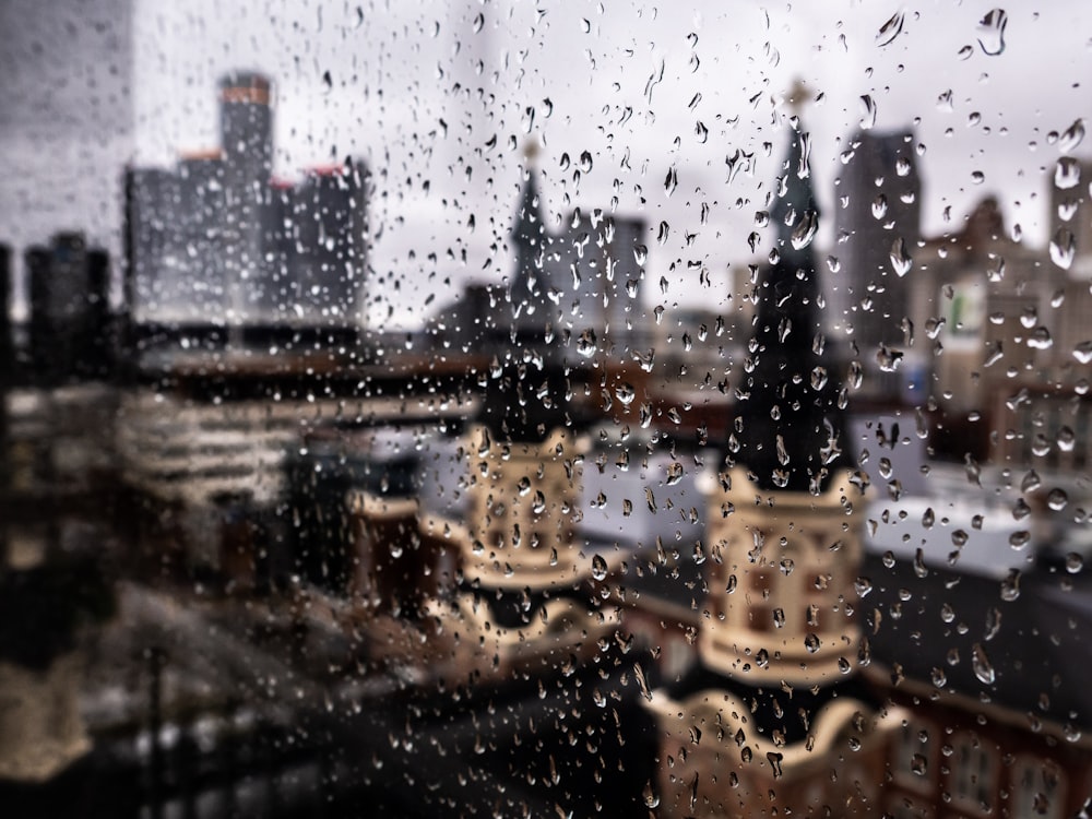 a view of a city through a rainy window