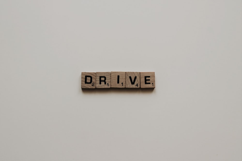 scrabble tiles spelling out drive word