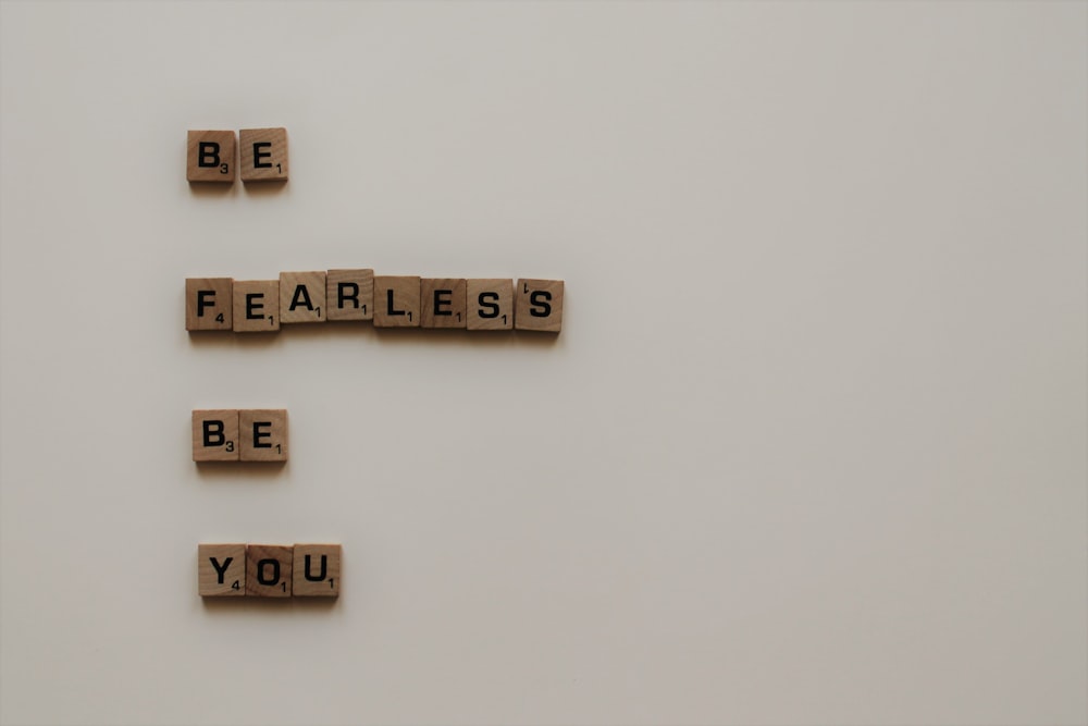 scrabble tiles forming be fearless be you phrase