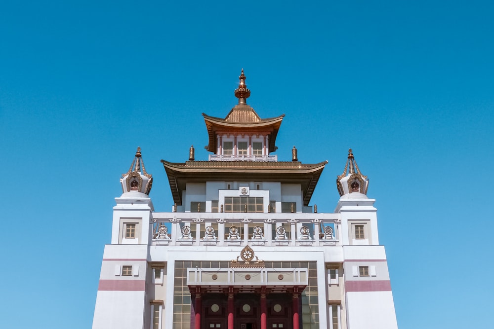 a tall white building with a red door