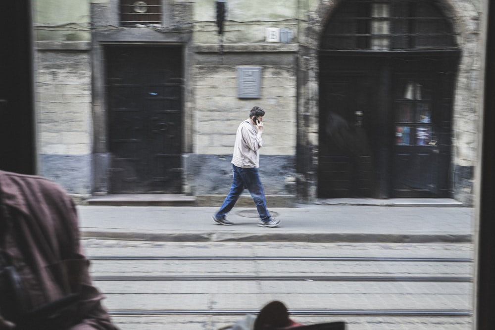 man walking in the street during daytime