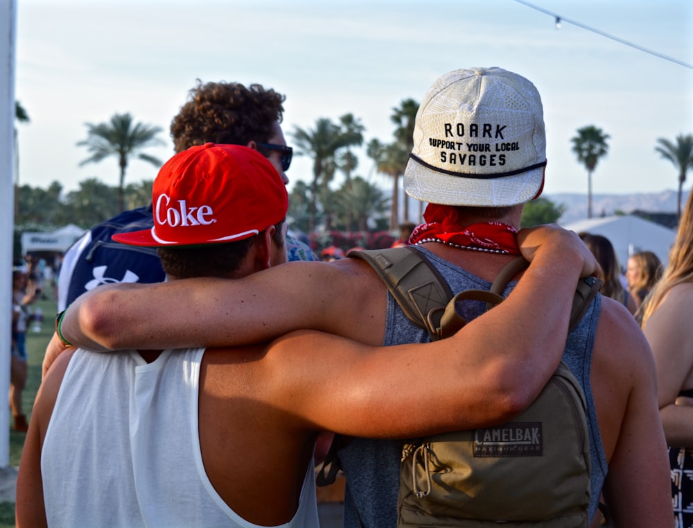 two men putting their hand over shoulders