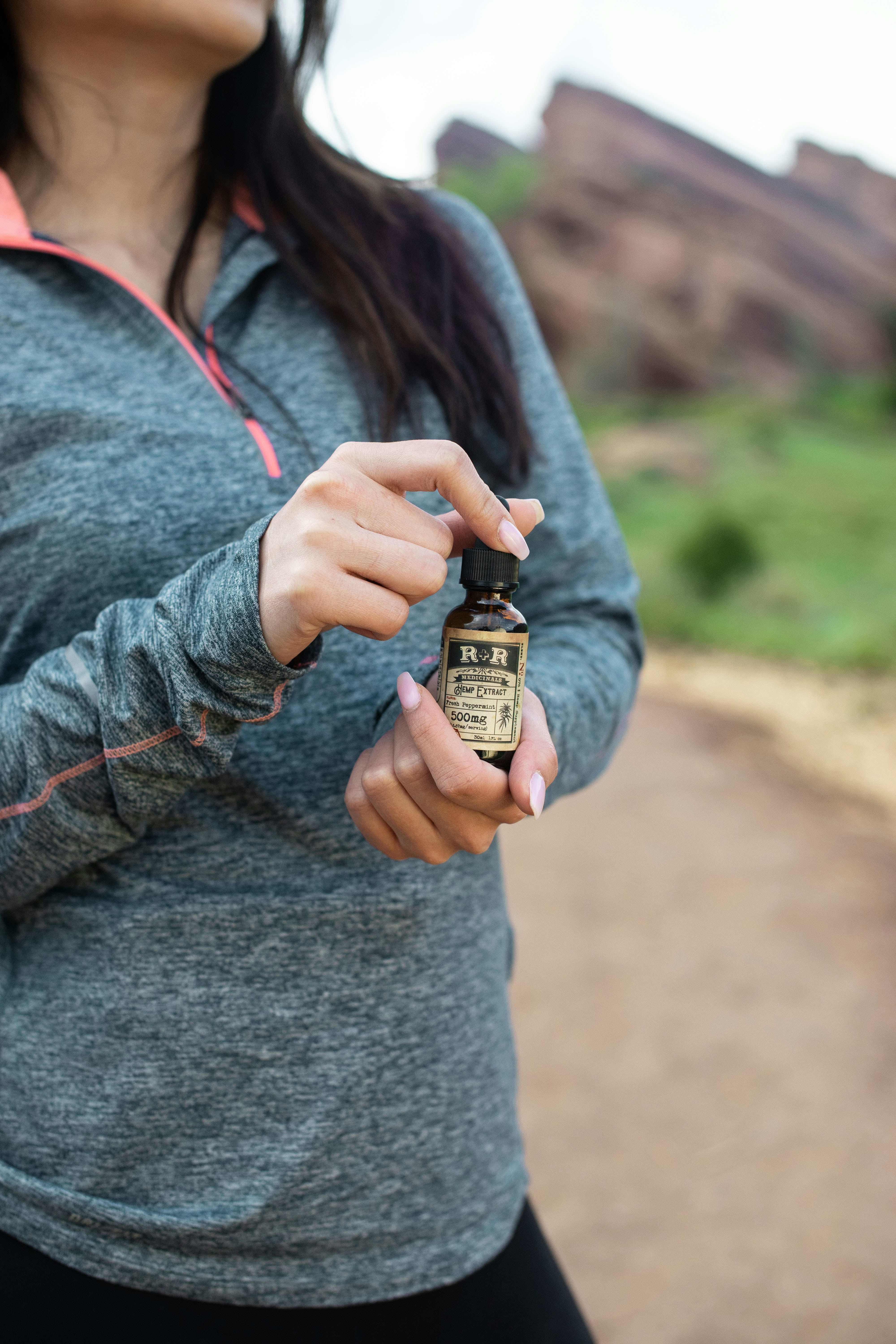 woman holding R&R bottle