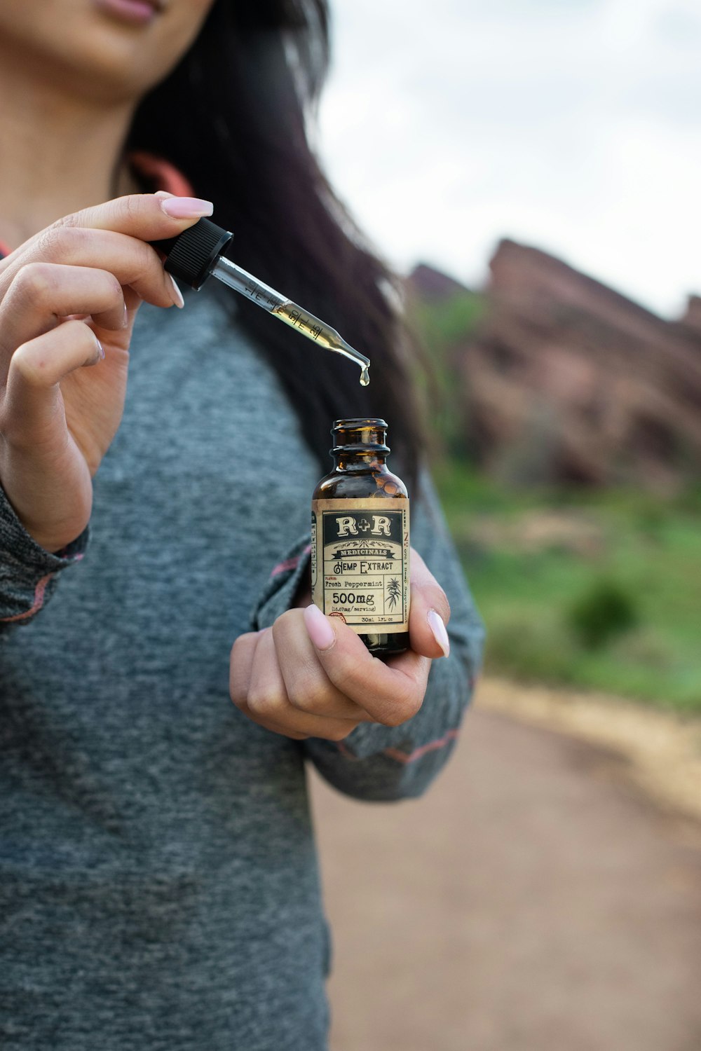 woman holding drop bottle