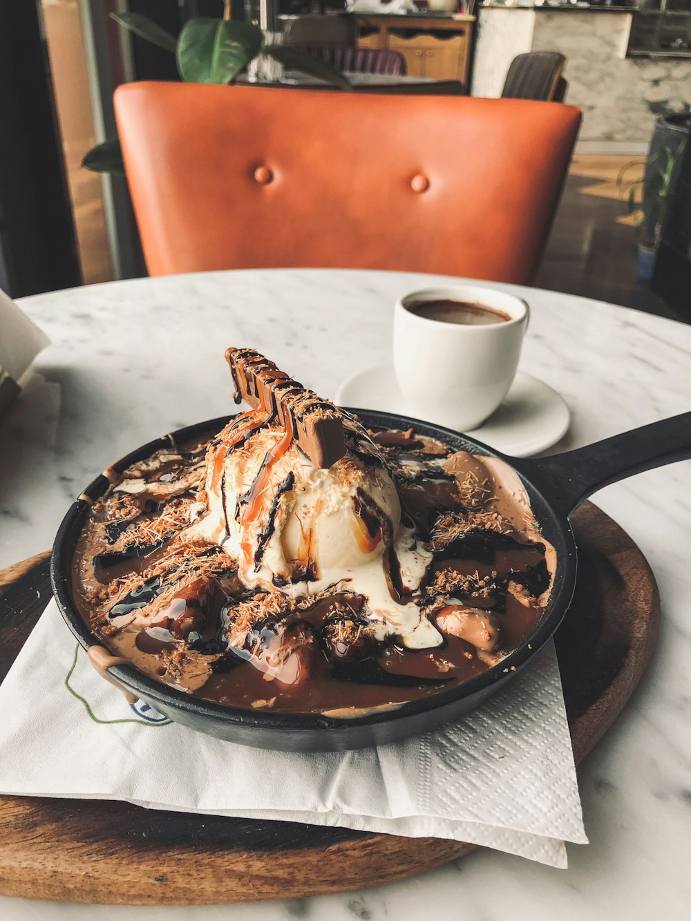 dessert in frying pan on wooden chopping board