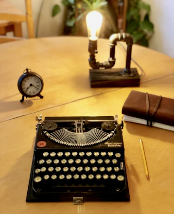 A sleek workspace with elegant books, a vintage typewriter, and soft golden light highlighting editorial tools.