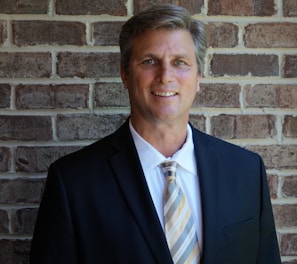 portrait photography of man wearing black suit jacket