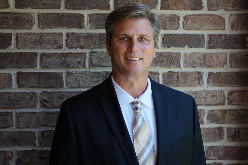 portrait photography of man wearing black suit jacket