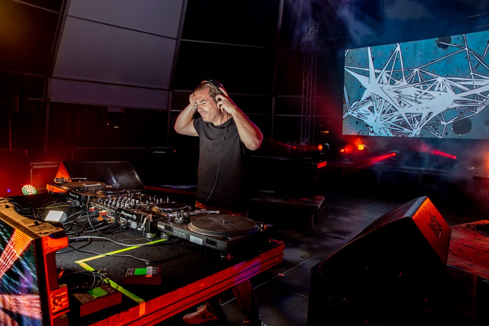 man surrounded by mixing consoles