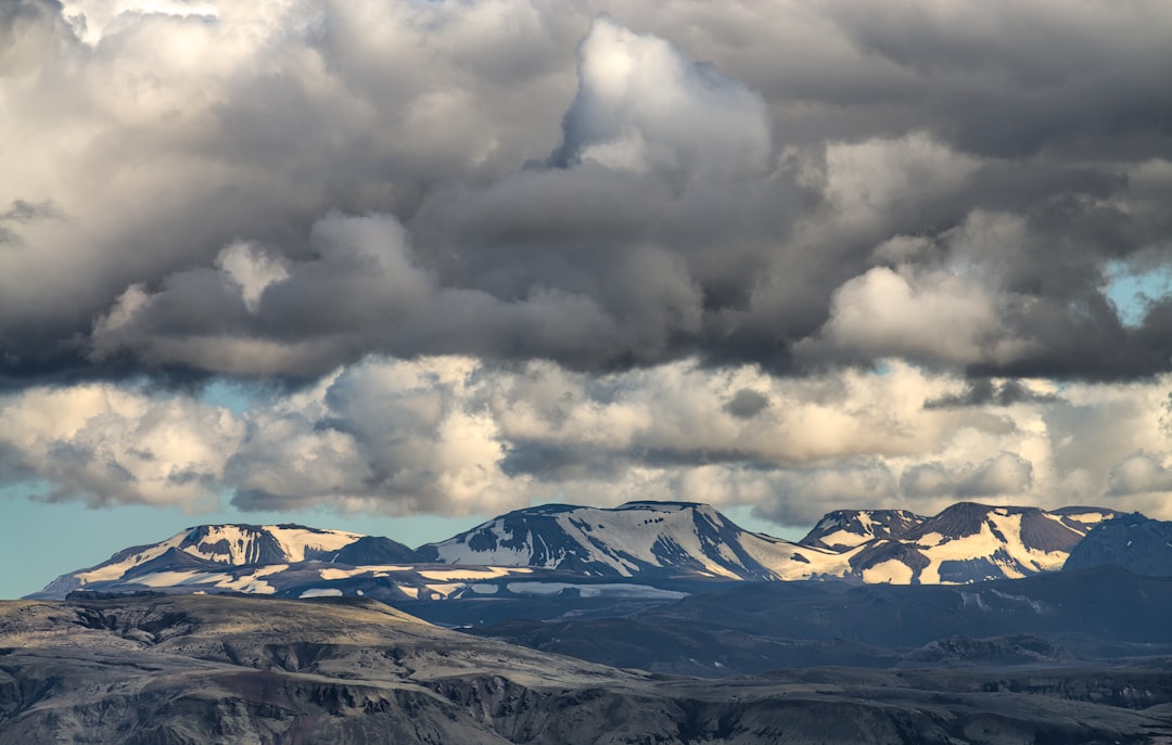 mountain covered with snow under white and gray skies