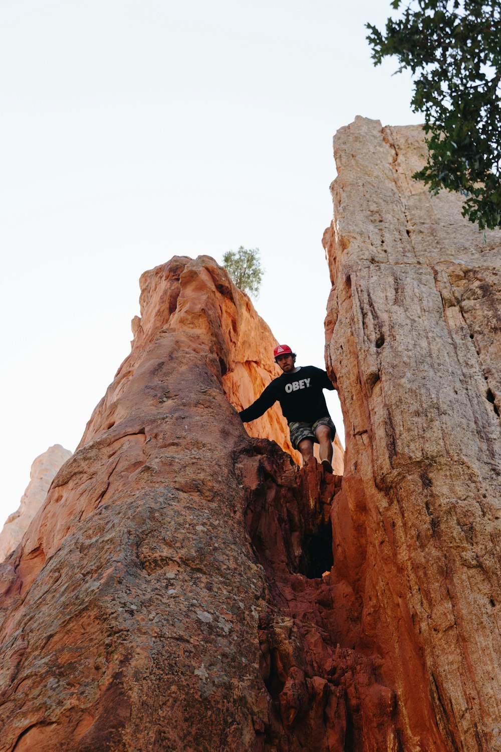 person standing between rock formation during daytime