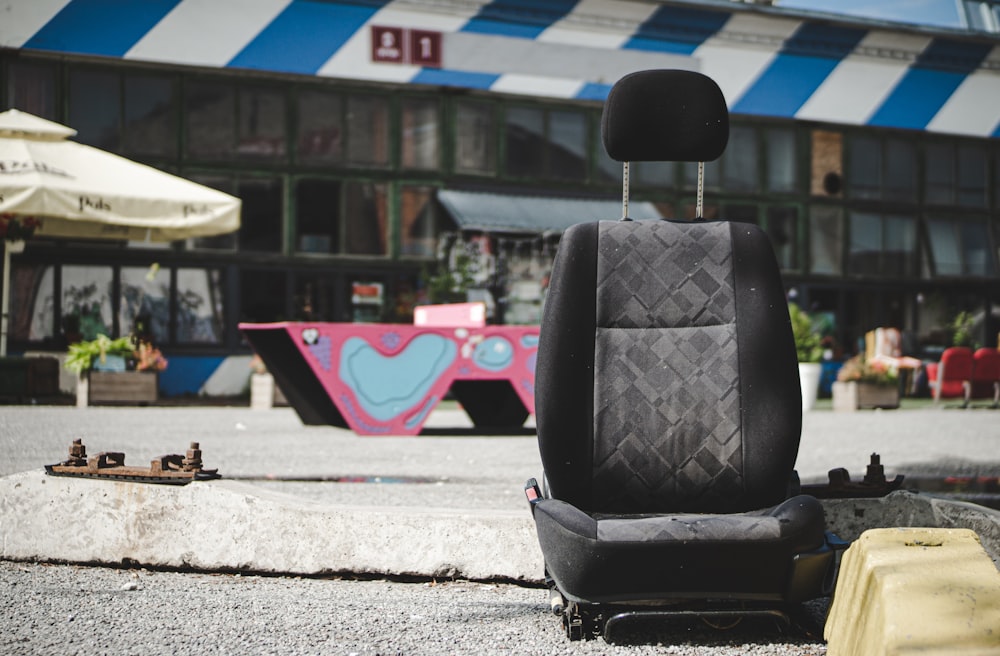 black car bucket seat on concrete floor