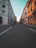 concrete road in middle of buildings during daytime