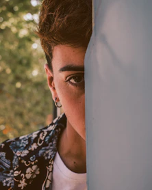 shallow focus photo of man wearing silver-colored hoop earring