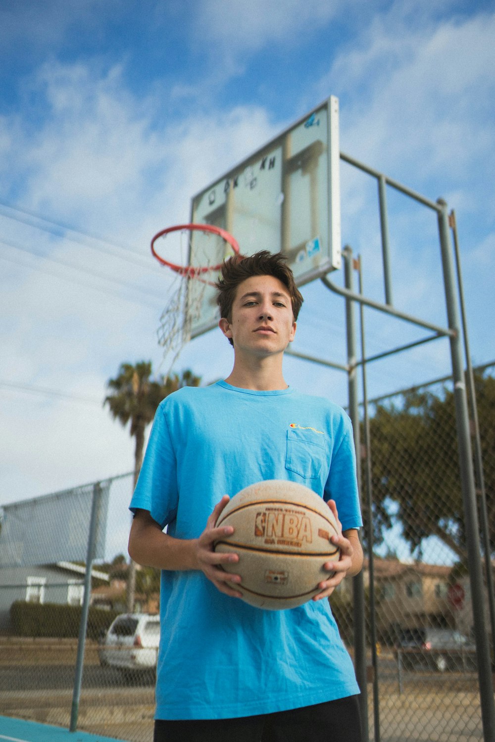 man holding basketball ball close-up photography