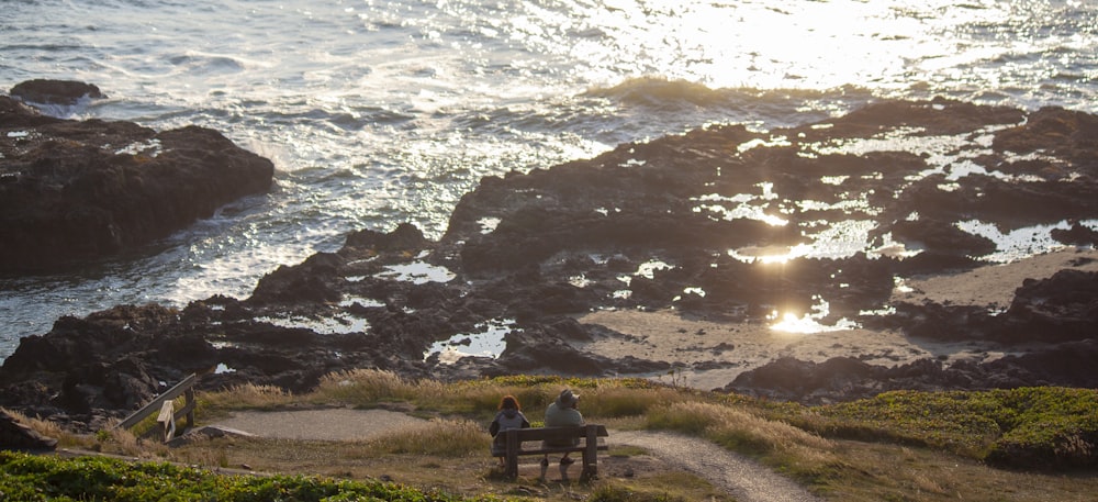 two people sitting on bench