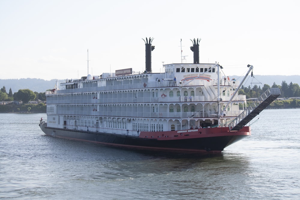 white cruise ship at the river during daytime