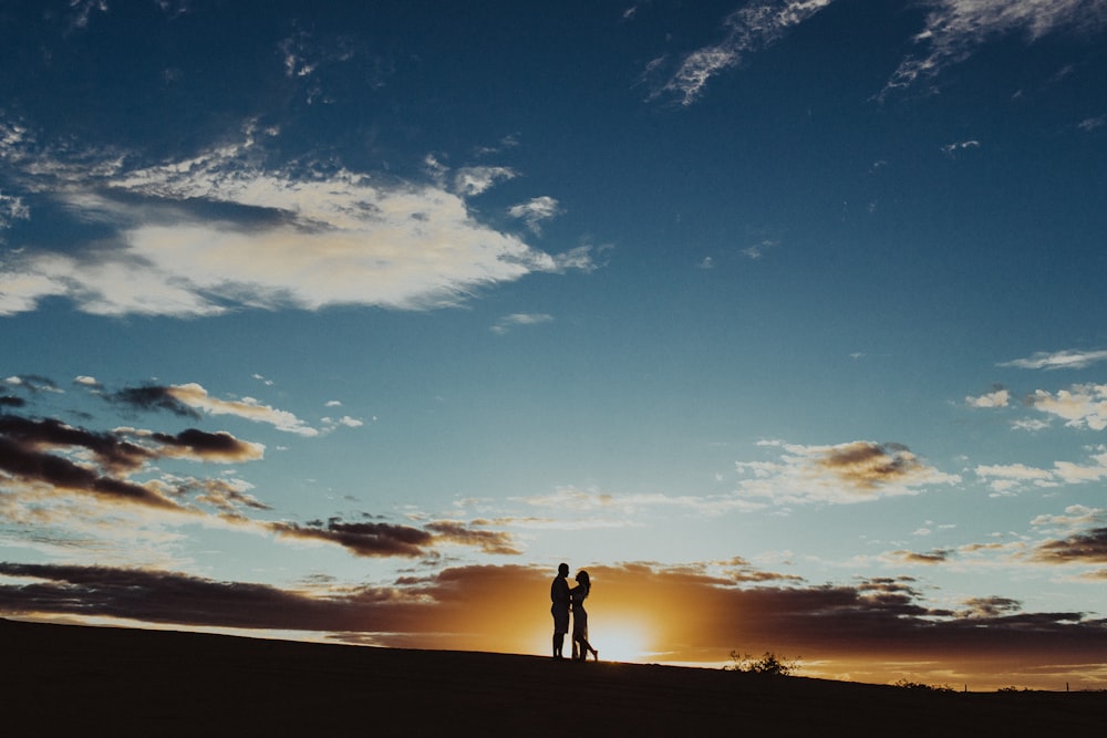 silhouette of two person standing