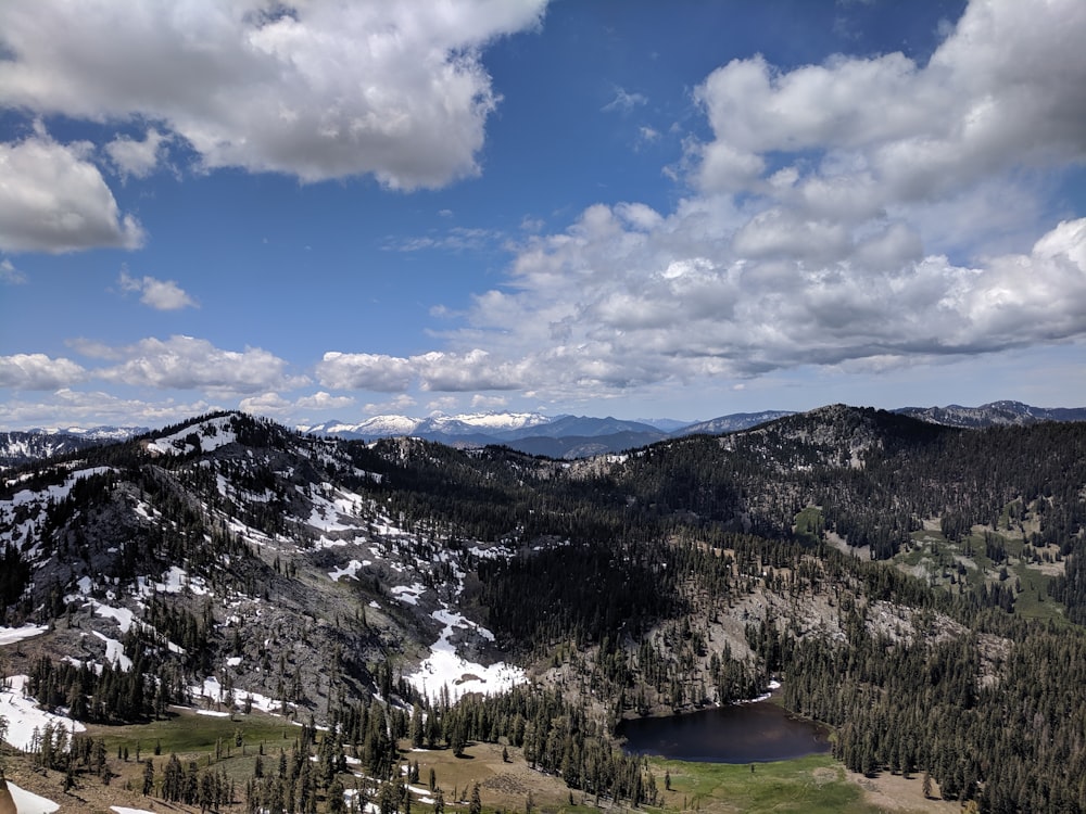 snow on mountains with trees