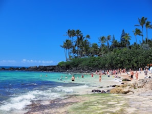 A vibrant tropical beach scene with smiling families enjoying the sun.