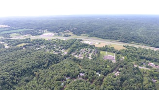 Aerial view of lush green plots near a highway, showcasing open spaces and potential for development.