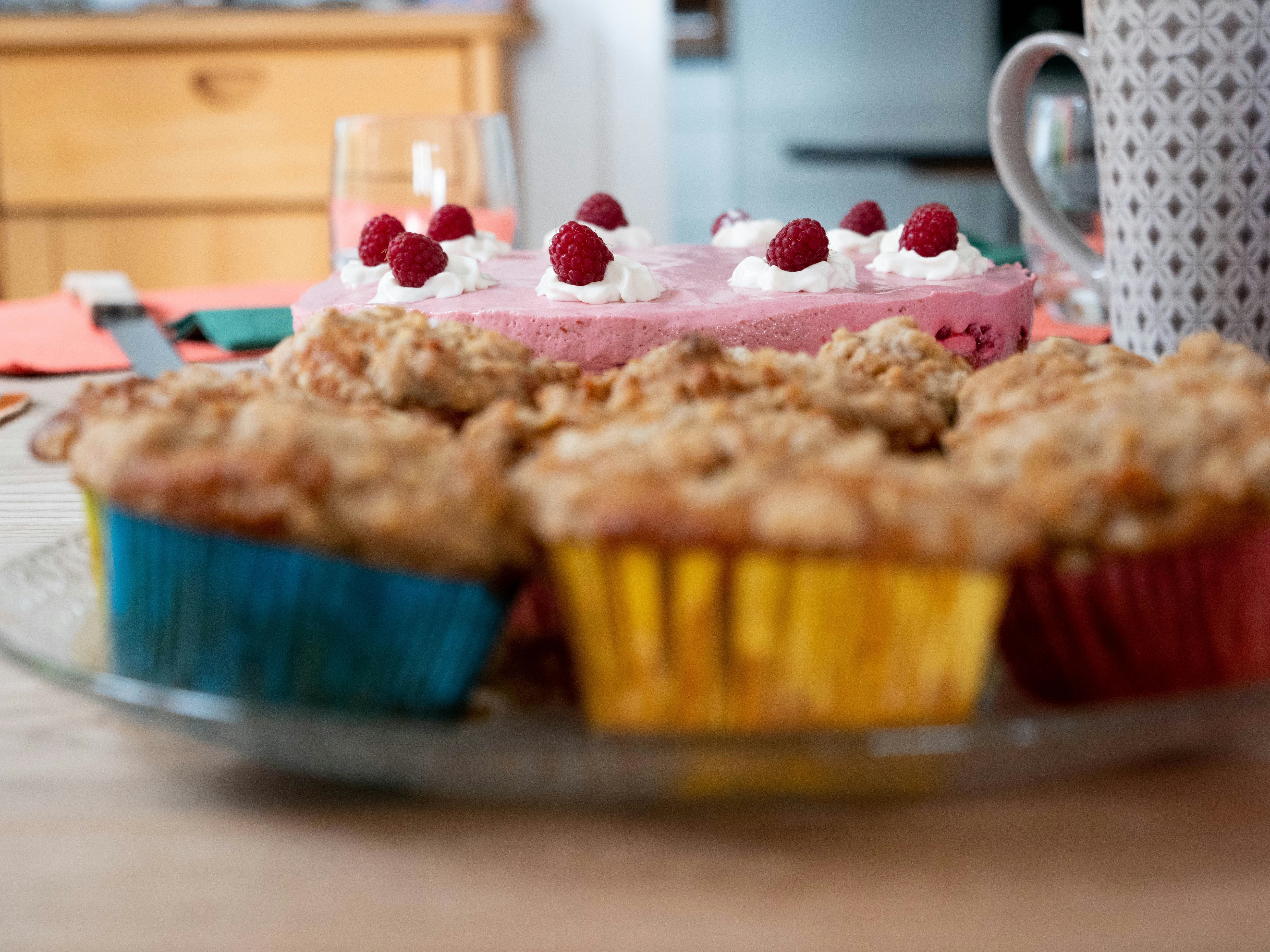 cupcakes near one layer cake with strawberries on top