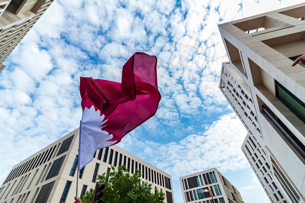 red and white flag between buildings