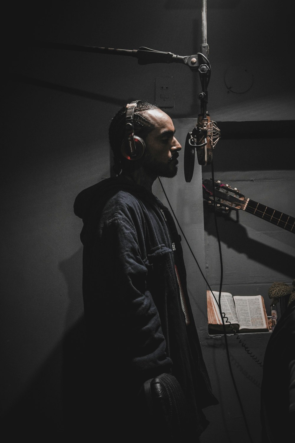 photography of singing man in front of pop filter inside r