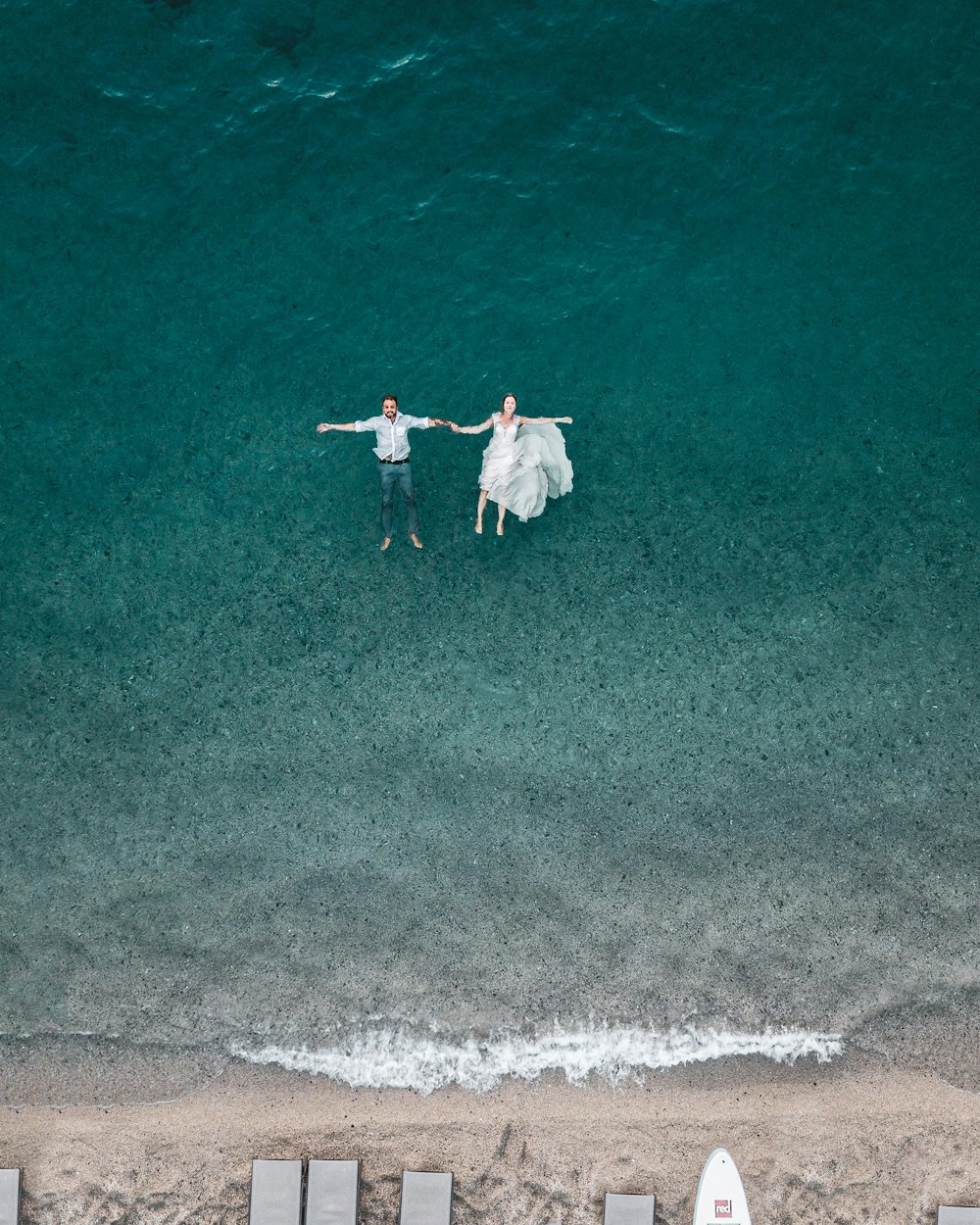Mann und Frau schwimmen am blauen Strand
