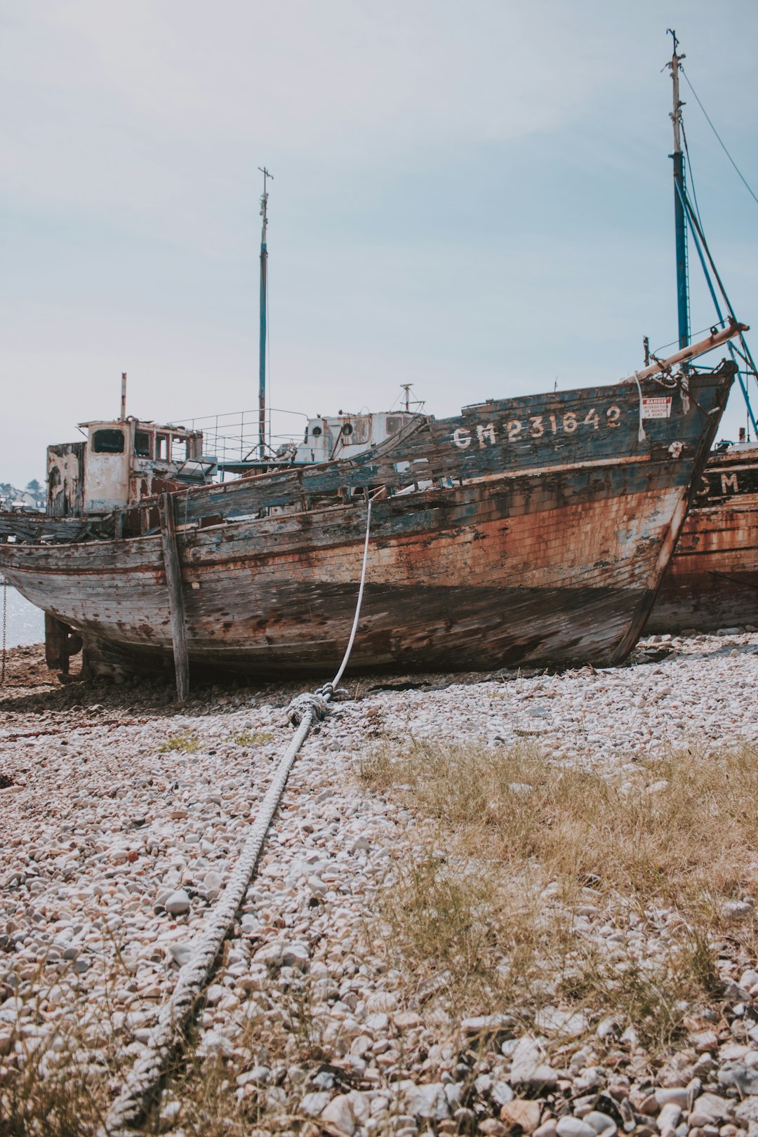 wrecked blue and brown fishing boat