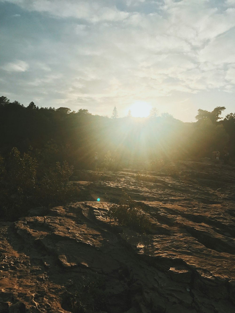 sun rays coming through rocky hill