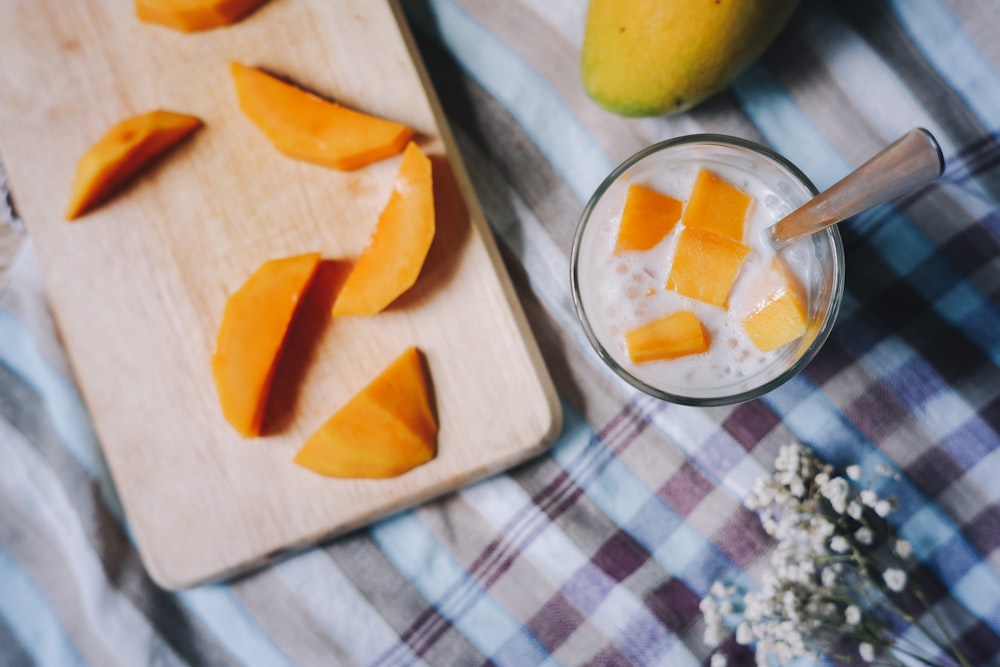 sliced riped mango fruits and mango drink