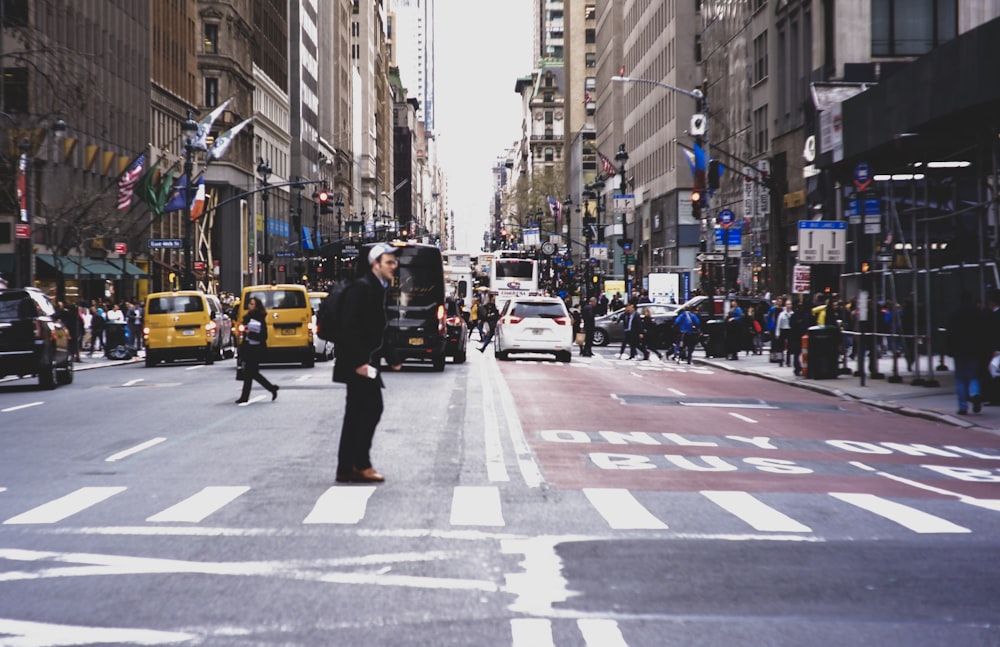 man on middle of road during daytime