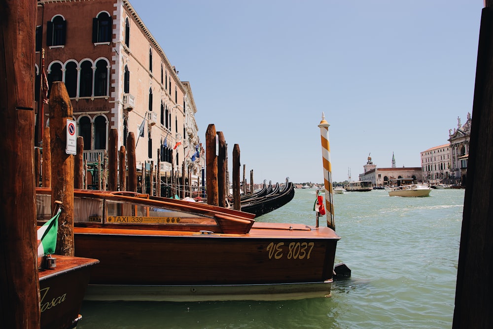 brown wooden speedboat at Venice canal