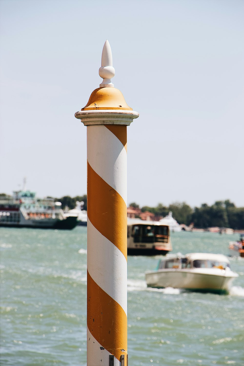 white and red striped post beside beach