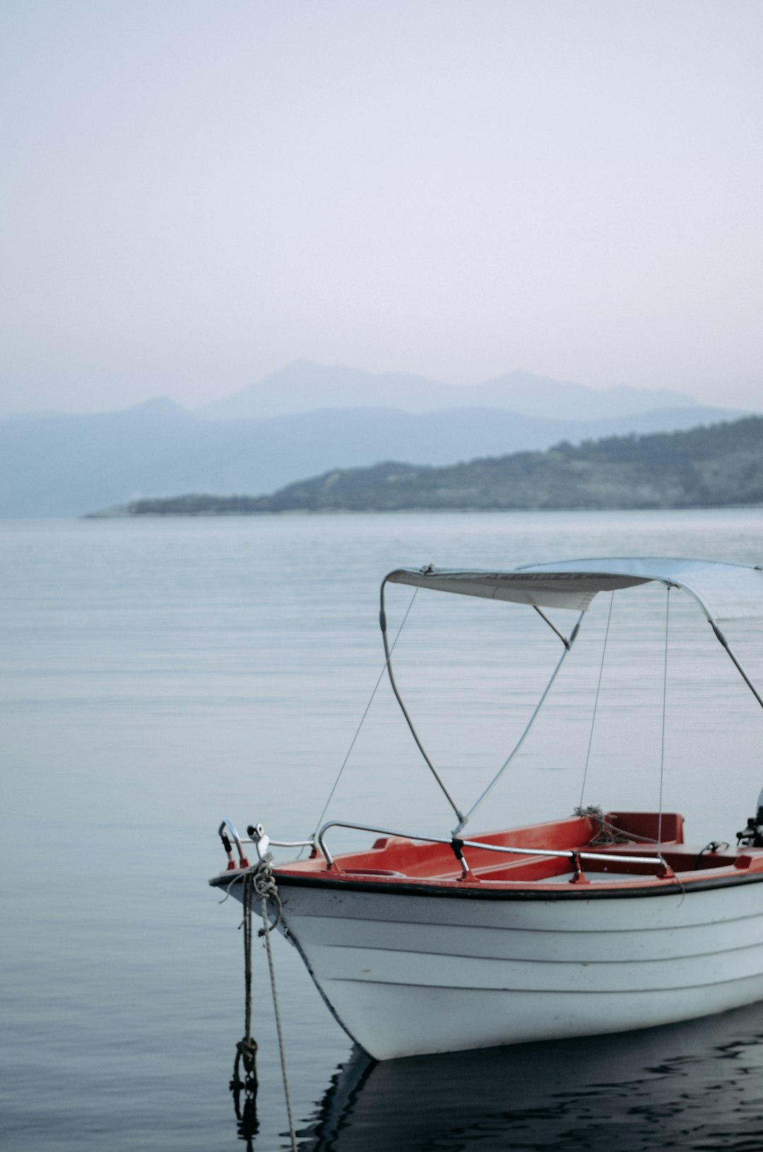 white and red boat on lake