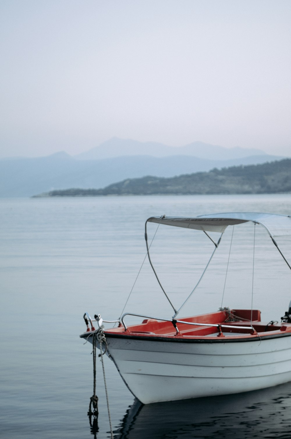 white and red boat on lake