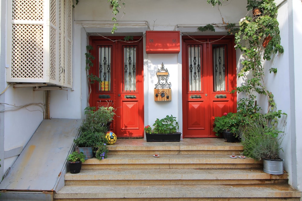 a couple of red doors sitting on the side of a building