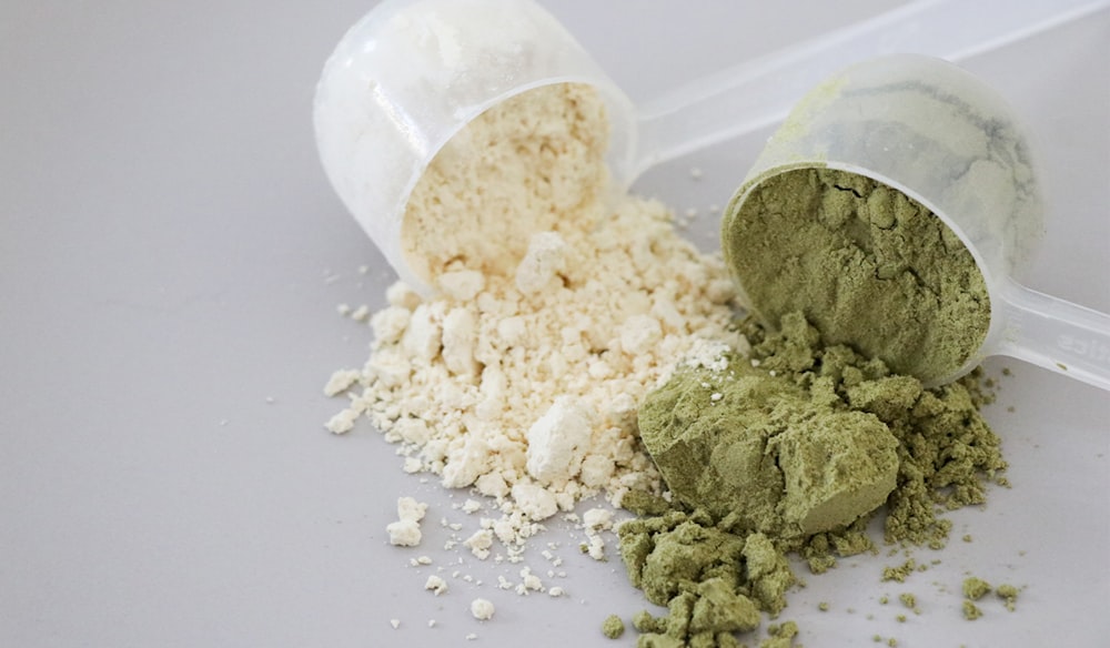 two scoops of white and green powders