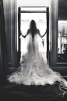 Artistic shot of a wedding dress train flowing gracefully across a marble floor.