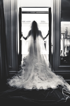 A full-length shot of a flowing silk wedding dress with a subtle train in soft natural light.