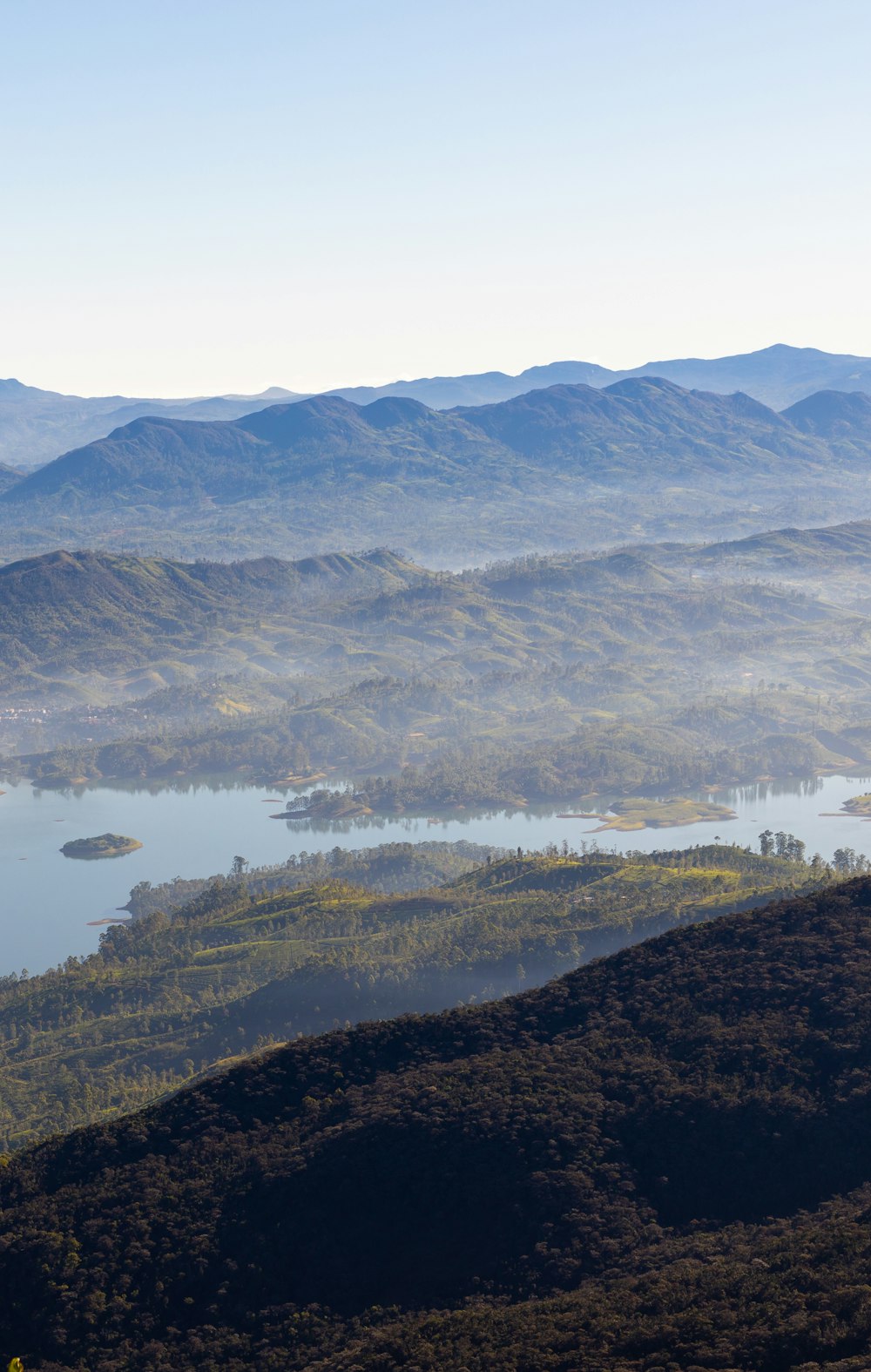 a view of a mountain range with a lake in the foreground