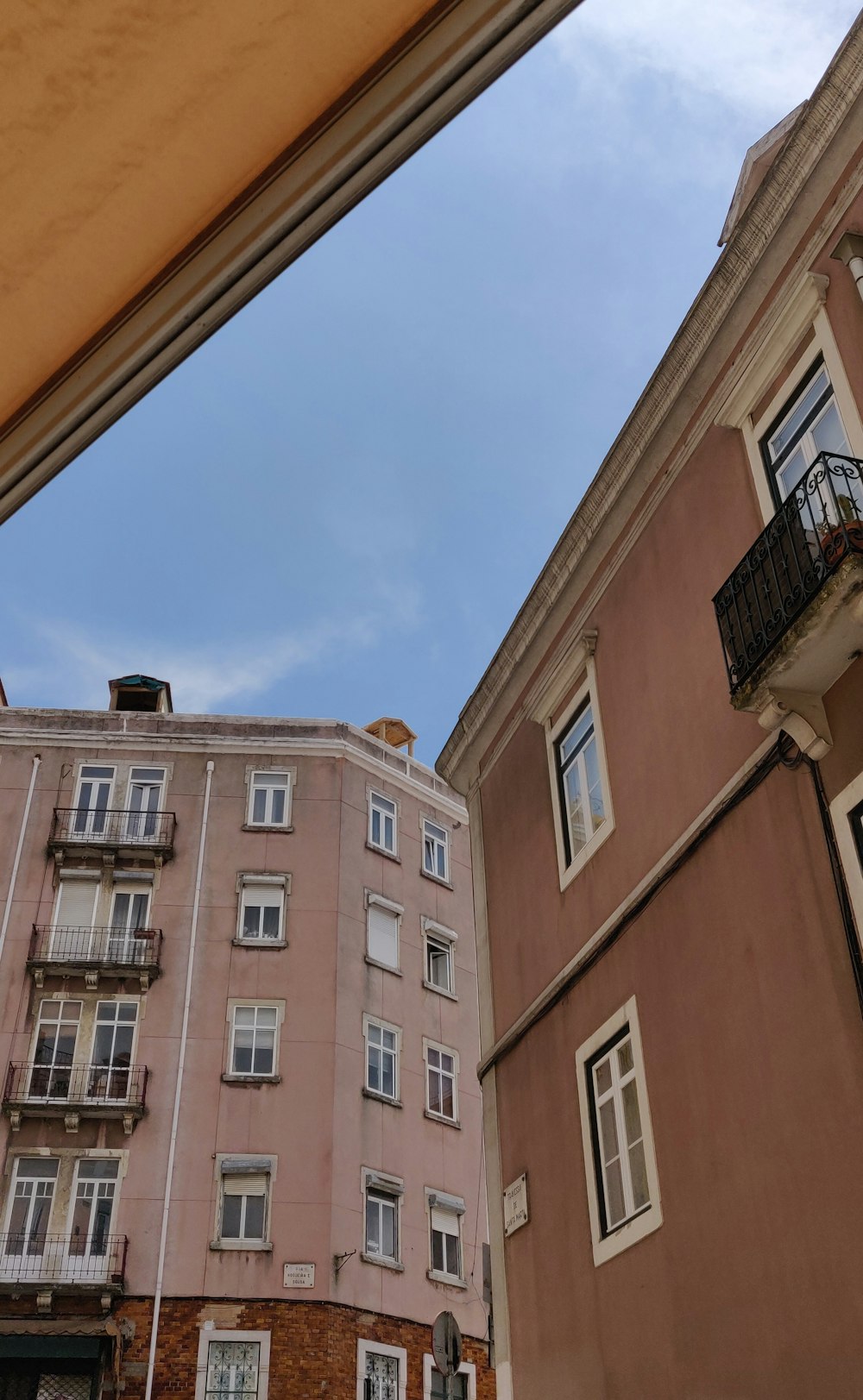 brown painted buildings under blue sky