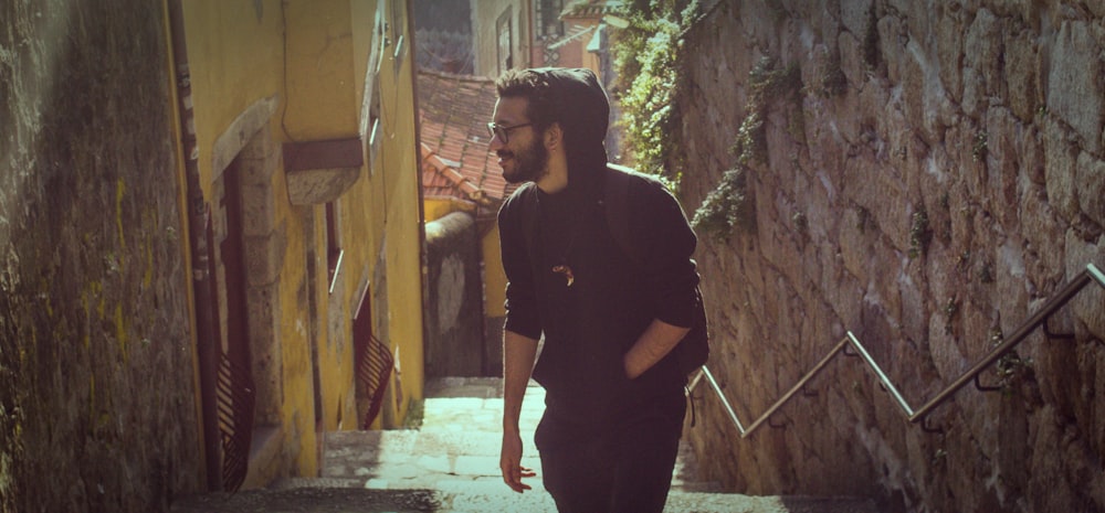 man at the stairs near concrete walls